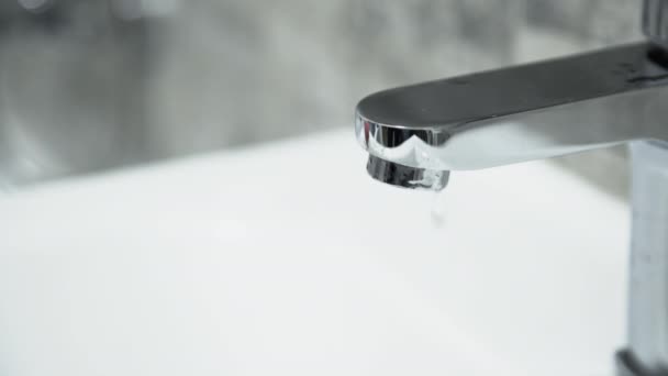 Faucet with dripping water drops on tile background. Close view — Stock Video