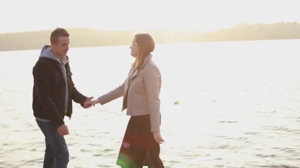 Happy girl leads her man on a quay and poses with smile on face — Stock Video