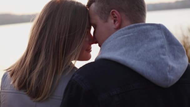 Portrait of romantic couple relaxing in caresses at lake — Stock Video