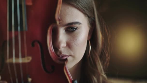 Mystérieux et passionné regard à la caméra de fille avec violon au visage — Video