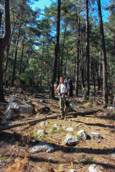 man tourist on Lycian trail in Turkey, forest and mountains