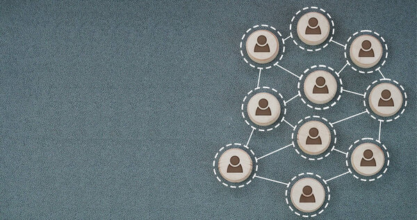 The wooden blocks of people are connected together with white lines. Concept of teamwork, interaction between people, network, rumor, communication and community.