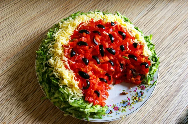 Delicious summer refreshing watermelon salad in the form of watermelon in a plate on the table. View from above.