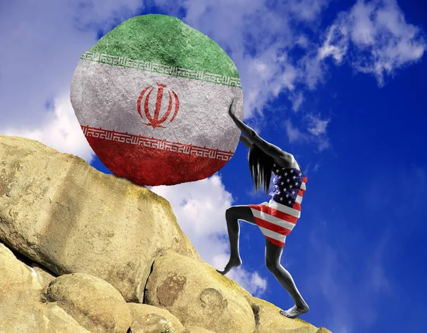 The girl, wrapped in an American flag, raises a stone in the mountain as a silhouette of the Iranian flag.