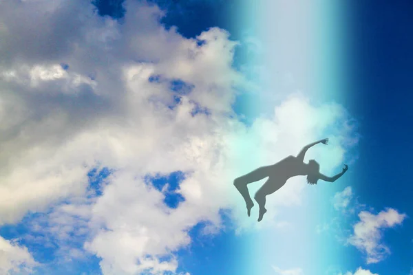 The dark silhouette of the soul of a deceased person ascends to heaven against a background of clouds. Afterlife, the concept of the immortality of the soul. 3D rendering