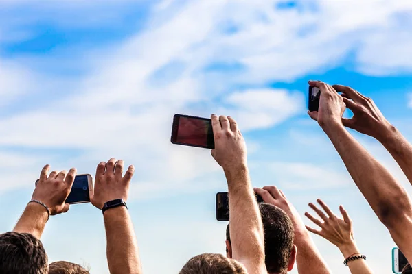 unidentified people shoot video on the phone, back view background image with place for text