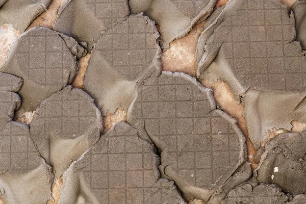 poor-quality tile laying, repair without qualifications, cracked cement glue, background photo