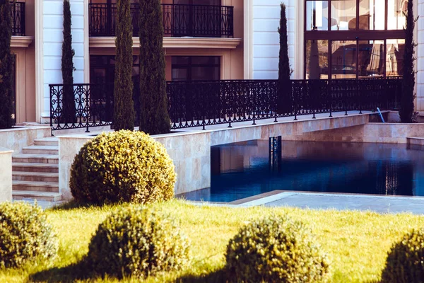 residential complex with a decorative pool and green well-groomed grass around, background image