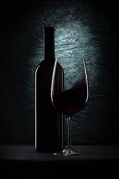 Glass of red wine and bottle — Stock Photo, Image