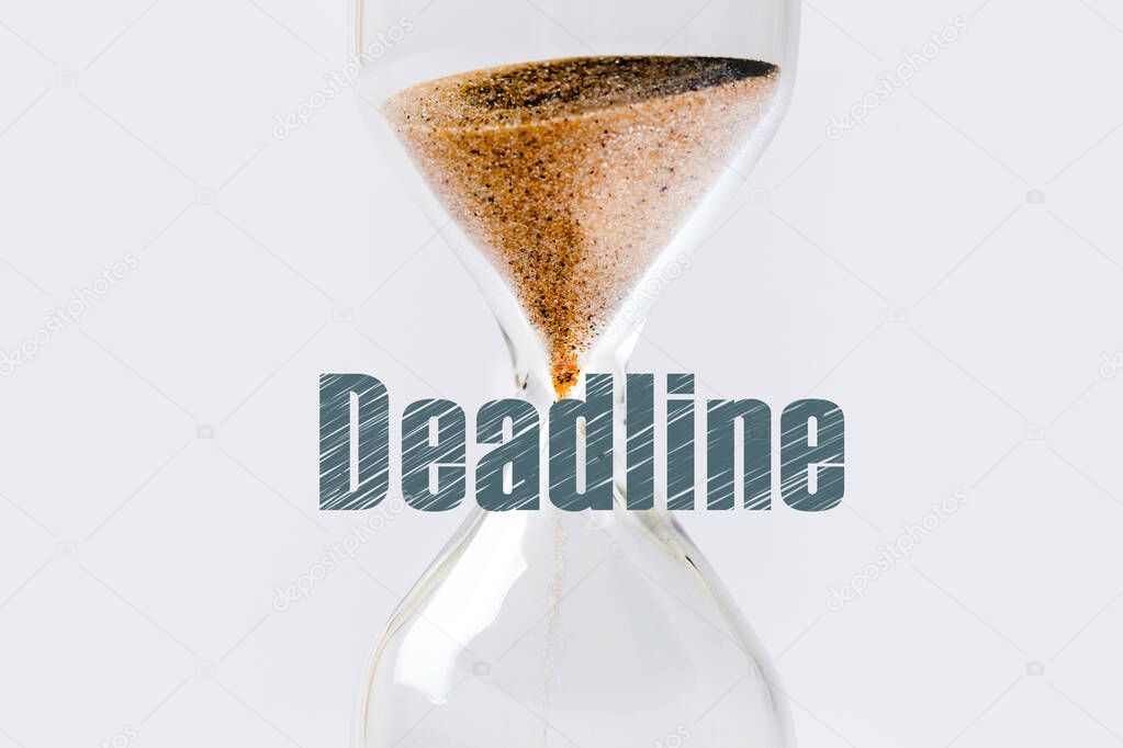 Sand flowing through an hourglass and deadline inscription