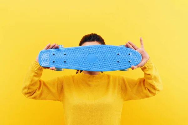 girl with skateboard over yellow background, mock-up image