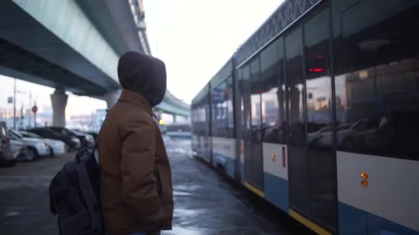 Ryssland. Moskva. Fundersam ung tonåring stående, väntar på spårvagnshållplatsen i staden — Stockvideo