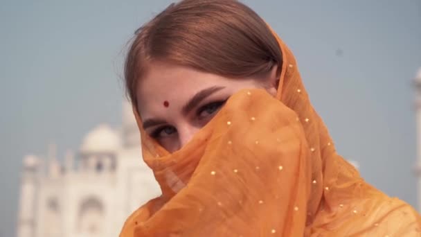 Hermosa mujer en Sari tradicional frente al Taj Mahal. background, Agra, Uttar Pradesh, India — Vídeo de stock