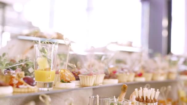 Mesa de banquete de catering bellamente decorada con diferentes aperitivos y aperitivos al sol en el evento de fiesta de cumpleaños de Navidad corporativa o celebración de la boda . — Vídeo de stock