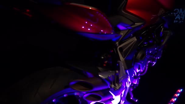 Close-up slow motion shot. Details of motorcycle at neon light — Stock Video