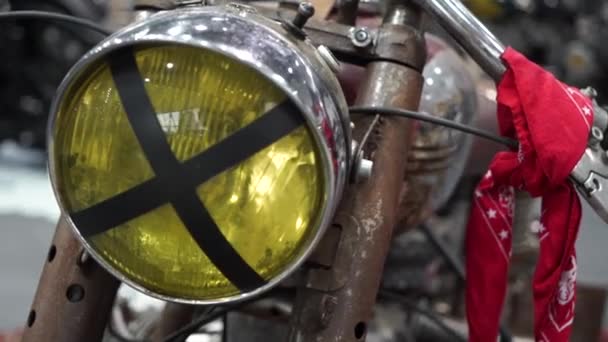 Classic motorbike parked in repair shop.Vintage motorcycle. Biker lifestyle. Vintage style cafe racer motorcycle in customs garage. Round headlight with grilles. — Stock Video