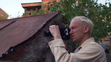 Hipster altın sonbahar parkta açık havada vintage eski film kamera vuruyor. Retro kamera ile kendi video filmi yapmayı denemek için mutlu Boy.