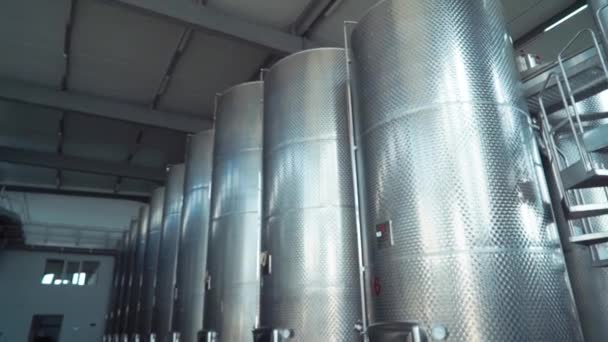 Large stainless steel wine distilling tanks. Silos for wine and beer fermentation . Steel barrels for fermentation of wine in winemaker factory . — Stock Video