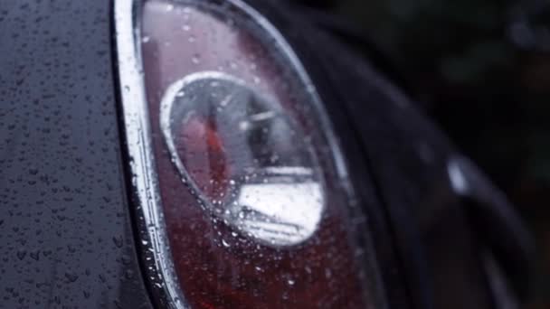 Closeup on a rear LED light of a car after the rain — Stock Video