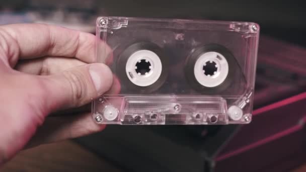 レトロなテープポータブルヴィンテージオーディオカセットレコーダーにオーディオカセットを挿入するマンハンド — ストック動画