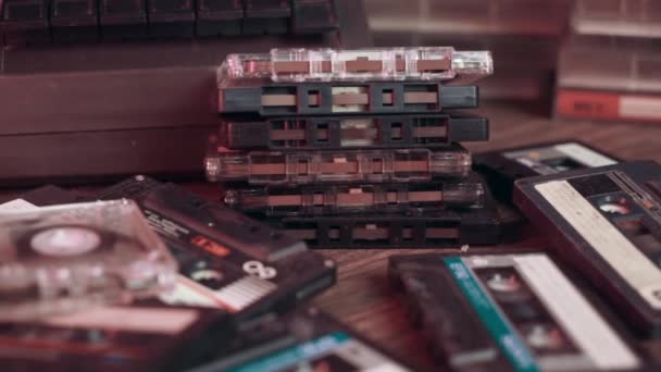 Old retro vintage cassette audio player and many different old retro audio cassettes on the table — Stock Video