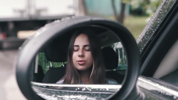 Reflection in car side mirror stylish girl with long hair look at camera — Stock Video