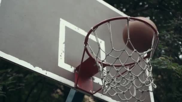 Stará basketbalová pálka s roztrženou sítí visící ve větru a loupaná barva — Stock video