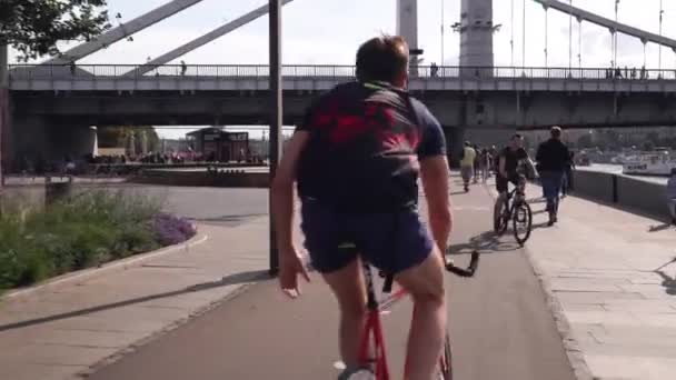 Moscú. Rusia. 2019.Jóvenes felices caminando y montando en bicicleta en el parque al atardecer. Grupo de amigos alegres que van a hacer un picnic al aire libre en verano . — Vídeo de stock