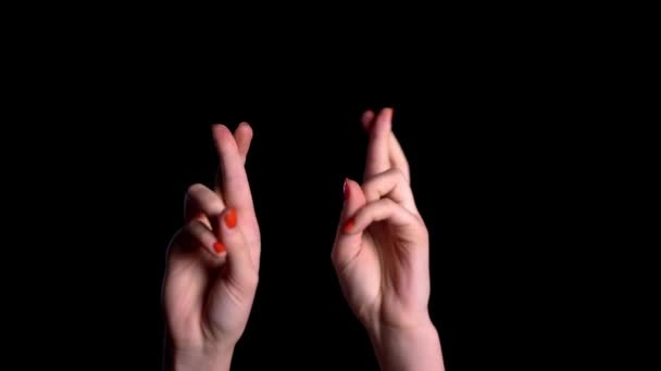 Woman hands praying with crossed fingers and rejoice after that over black background — ストック動画