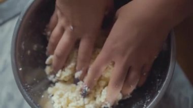 Muzlu peynirli peynirli kek yapma süreci. Kadınların elleri peynirli kekler için malzemeleri karıştırır.