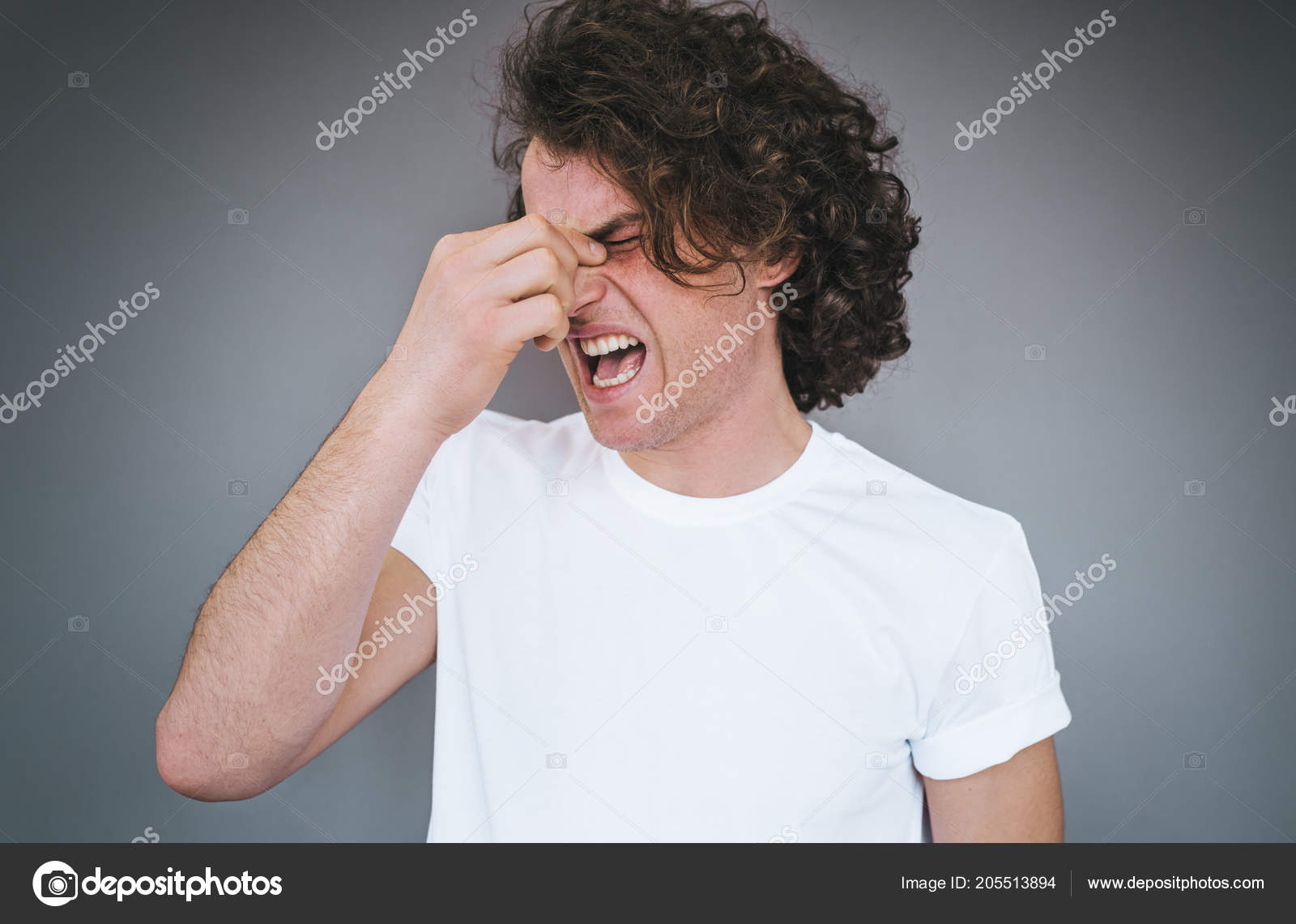 Studio Portrait Curly Hair Male Has Headache Massaging Nose Bridge