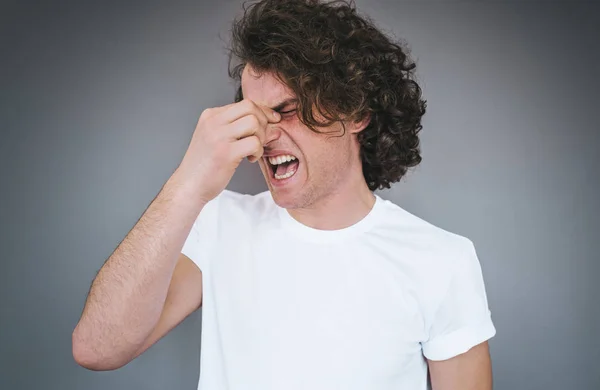 Studio Portrait Curly Hair Male Has Headache Massaging Nose Bridge — Stock Photo, Image
