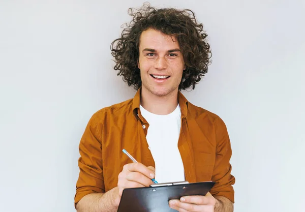 Horizontal Shot Handsome Male Student Curly Hair Writes Diary Plan Royalty Free Stock Photos