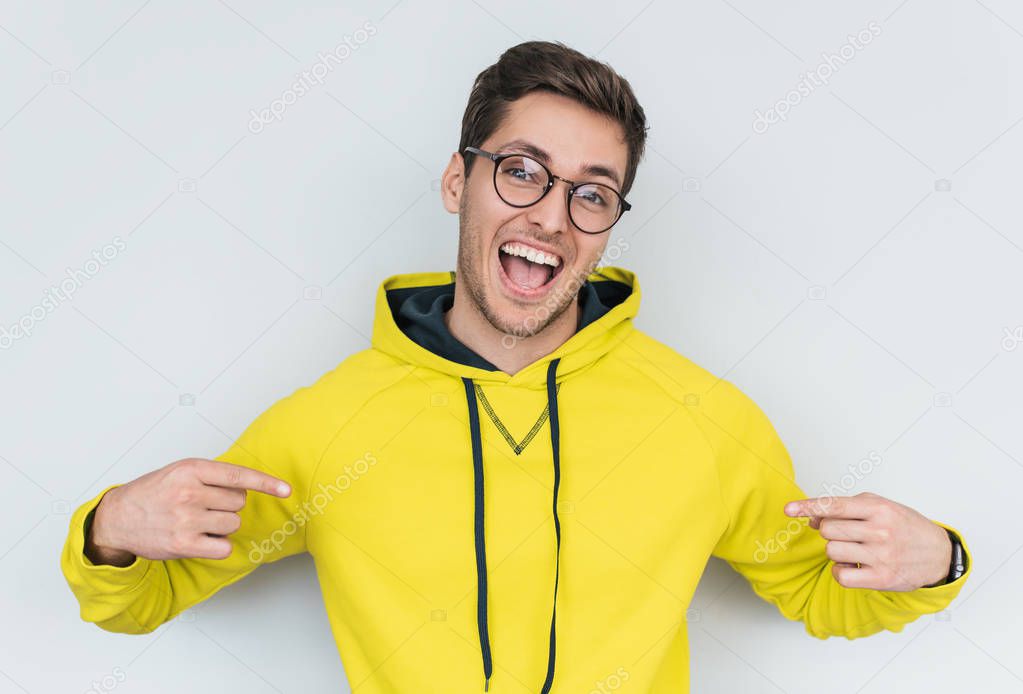 man in yellow hoody and trendy glasses isolated on white background