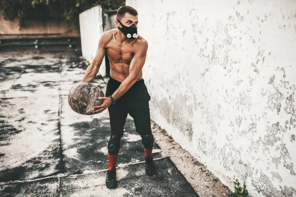 Fitness Athlete Male Doing Exercises Medicine Ball Mask Concrete Background — Stock Photo, Image