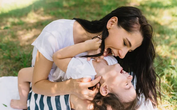 美しい母の肖像画と少し笑みを浮かべて娘を屋外プレイします かわいいお母さんと彼女の子供が公園で一緒に遊んで 幸せな家族 幸せな母の日 — ストック写真