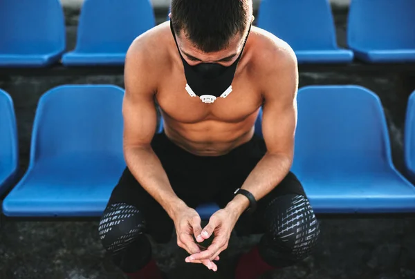 Horizontal Image Young Muscular Male Sitting Seat Stadium Mask Exercises — Stock Photo, Image