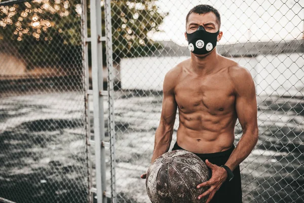 Young Muscular Male Posing Medicine Ball Mask Outdoor Next Grid — Stock Photo, Image