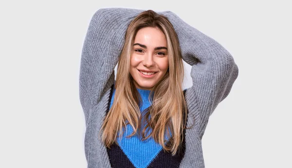 Indoor studio shot of charming friendly-looking European young woman in stylish loose sweater, smiling broadly and looking to the camera, isolated over white background. People emotions concept — Stock Photo, Image