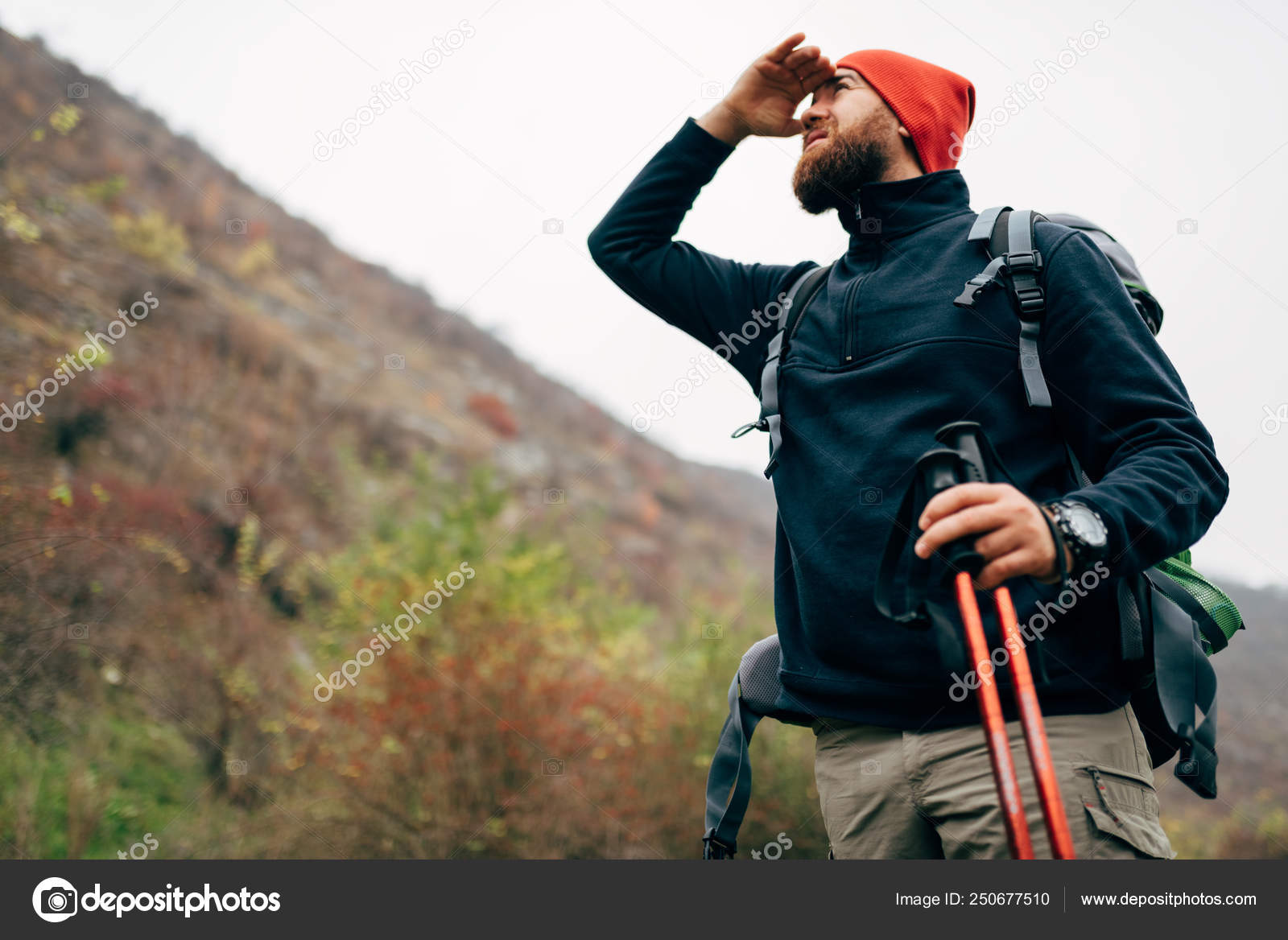 Outdoor horizontal shot of handsome hiker young man hiking in mountains