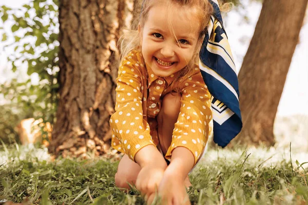 행복한 어린 소녀는 광범위하게 미소와 자연 배경에서 재생합니다. 공원에서 여름을 즐기는 쾌활한 아이. 행복한 아이는 재미와 햇빛에 숲에서 탐험. 행복한 어린 시절 — 스톡 사진