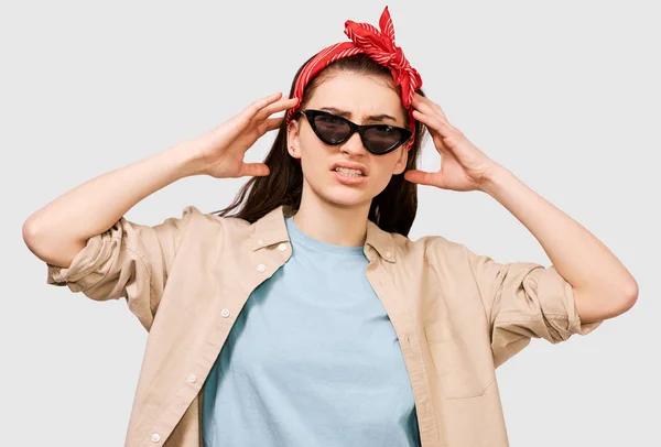 Mad young student lady frowning her face and looking seriously at the camera. People and emotions concept