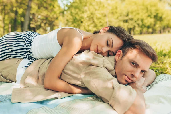 Image of romantic couple in love dating outdoors at the park on a sunny day. Happy couple lying on the grass during picnic in the nature background. Valentine day. Happy relationship — Stock Photo, Image