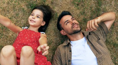 Sevgi dolu bir babanın açık hava aktivitesi vardır. Kızı çimlerin üzerinde yatar, gökyüzüne bakar ve hayal gücü arar. Baba ve küçük kız birlikte eğleniyorlar. Babalar günün kutlu olsun.