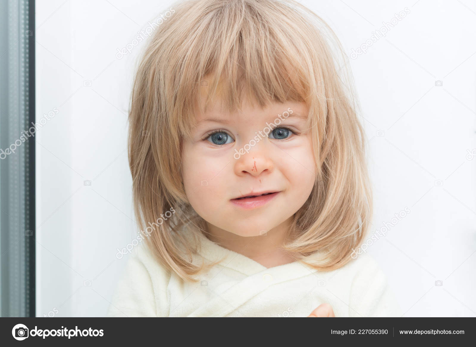 Headshot Of Adorable Cute Blonde Female Child Looking At Camera