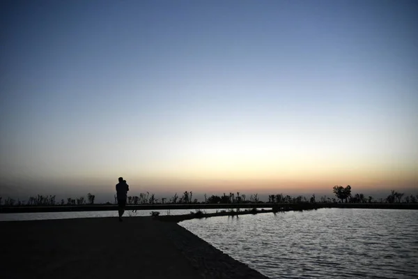 Silhouette Man and Baby at Lake on the sunset at Al Qudra love l — Stock Photo, Image