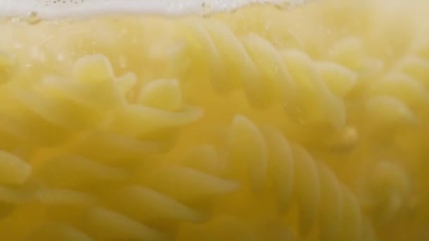 Fusilli pasta cooking boiling in water — Stock Video