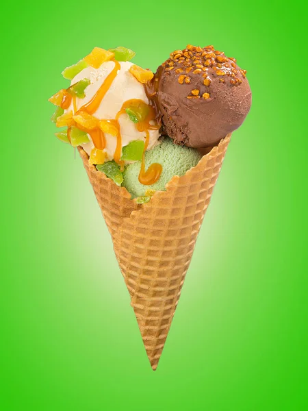 Pistachio, chocolate and vanilla ice cream balls with caramel sauce and nuts in waffle cone on a color background — Stock Photo, Image