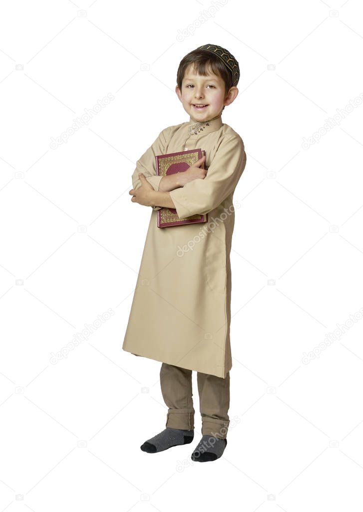 Happy muslim kid holding holy Quran on white background