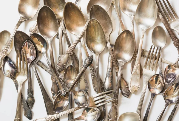 Spoons, forks, knives, silverware pattern on white background. Kitchen texture Top view